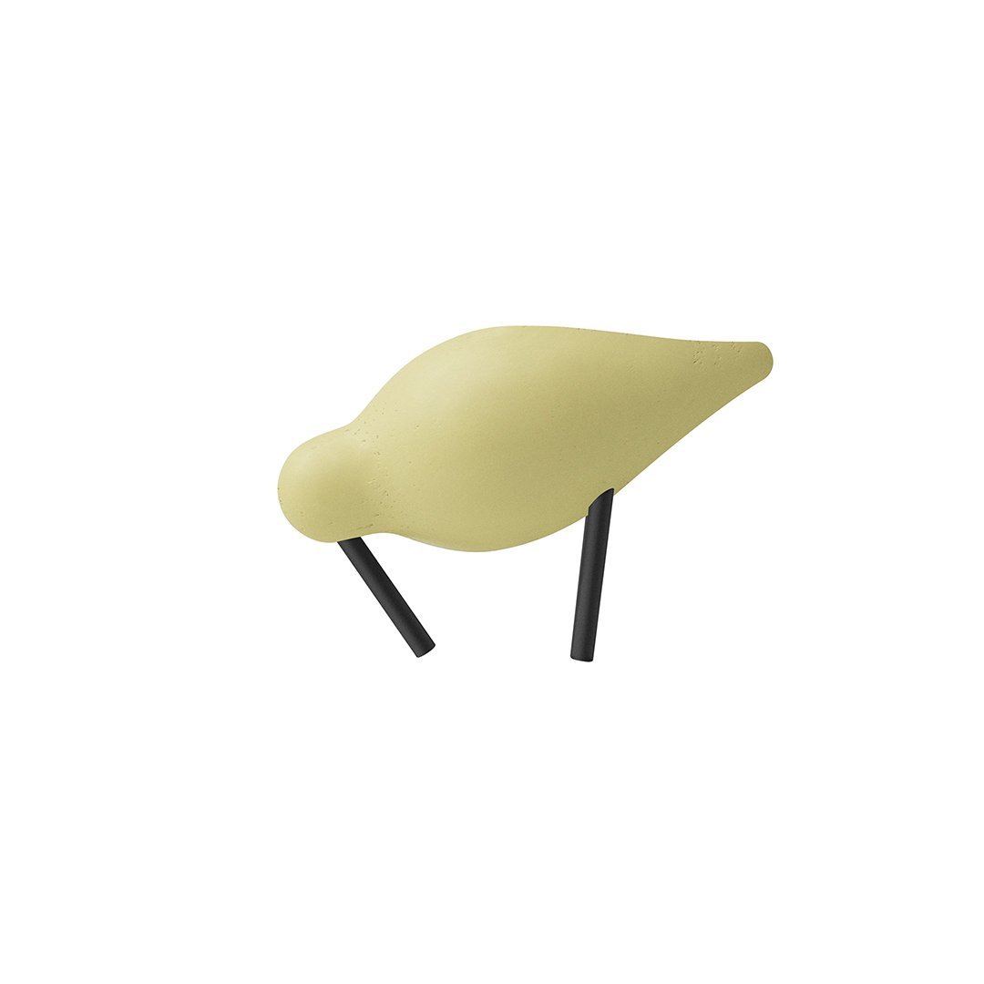 Soft yellow bird figurine with smooth surface and black legs, perfect for modern decor.