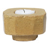 Natural textured yellow candle holder with a geometric design, featuring a minimalist white candle on top.
