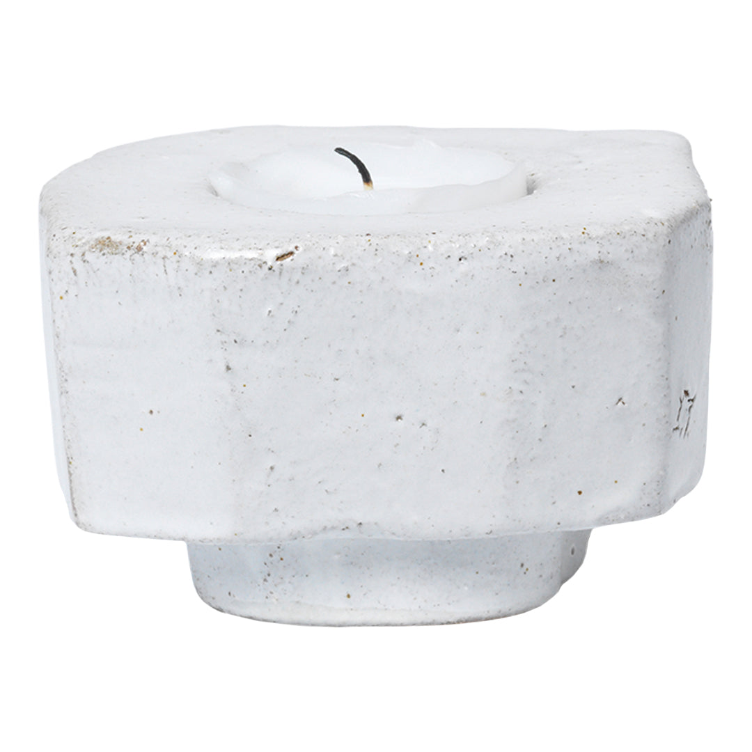White textured candle holder with an organic shape and subtle speckled patterns, perfect for modern decor.