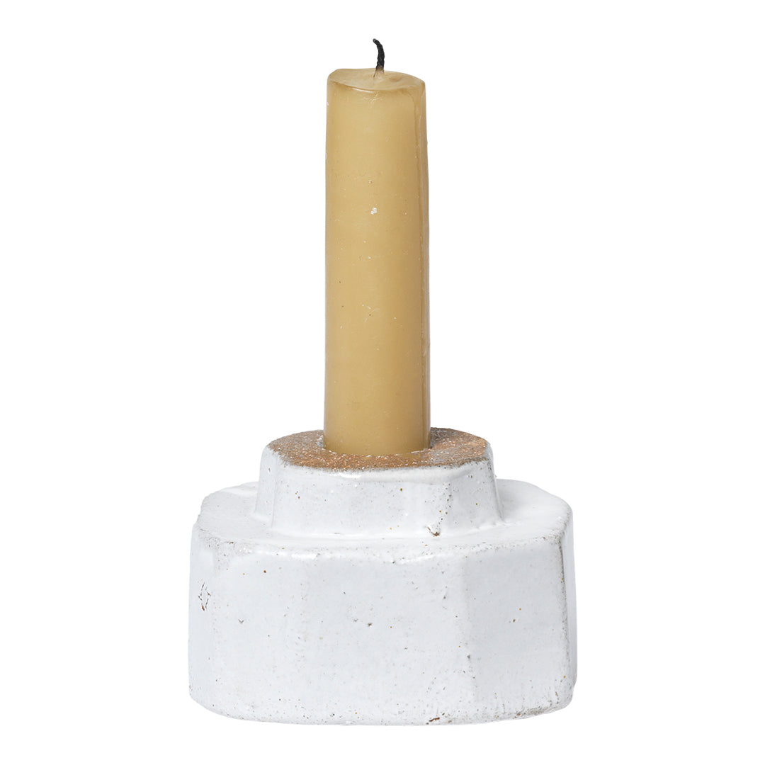 White textured candle holder with a smooth yellow candles, perfect for a cozy, modern decor.