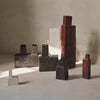 "Set of modern geometric vases in earthy tones: red, green, black, white, and gray, with textured finishes."