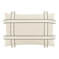 Beige pillow with black grid pattern and contrasting lines, perfect for modern decor.