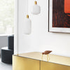Gold accents with white and earthy tones; modern art piece with bold orange against neutral backdrop.