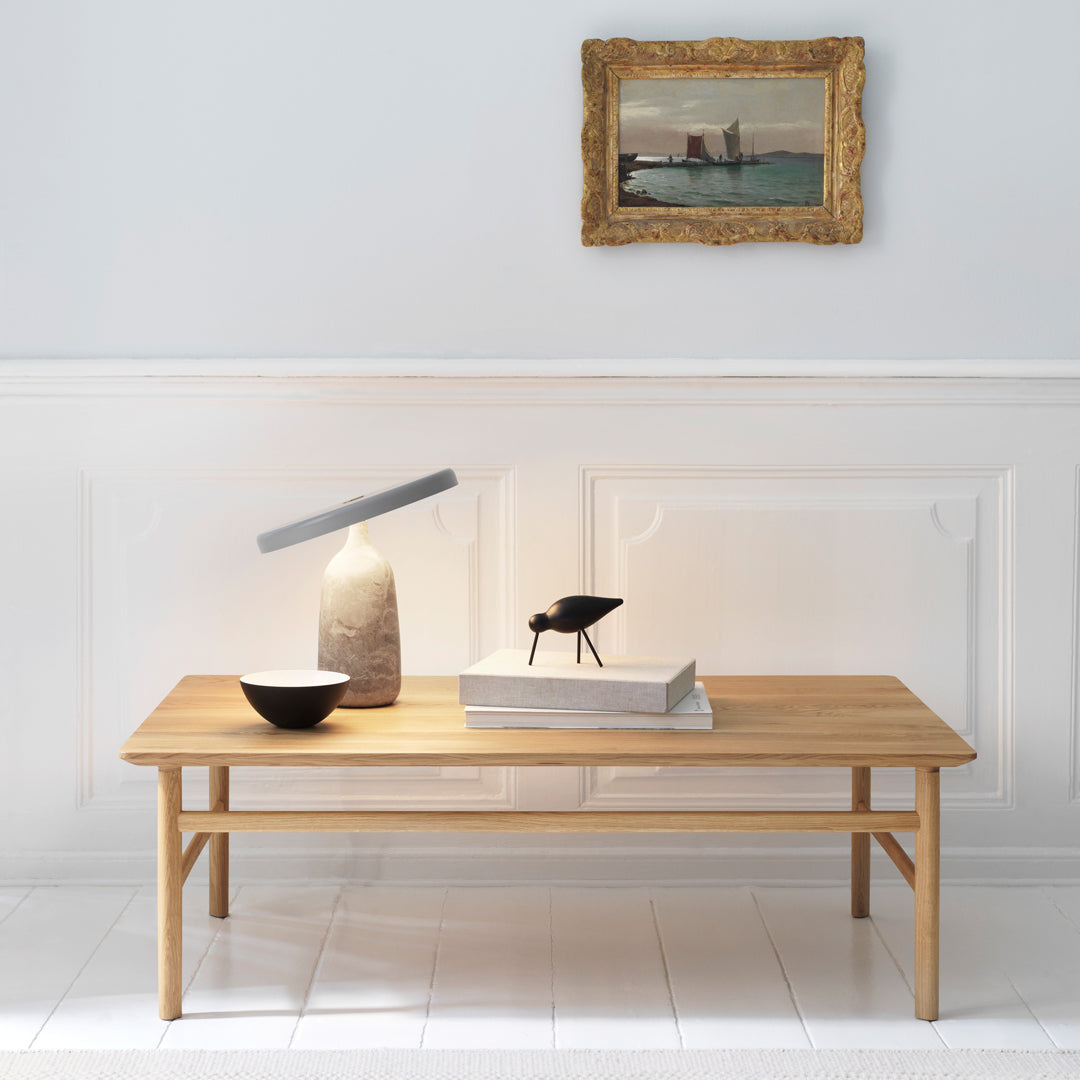 Natural wood coffee table with a smooth finish, featuring a minimalist design in light brown tones. Elegant, contemporary style.