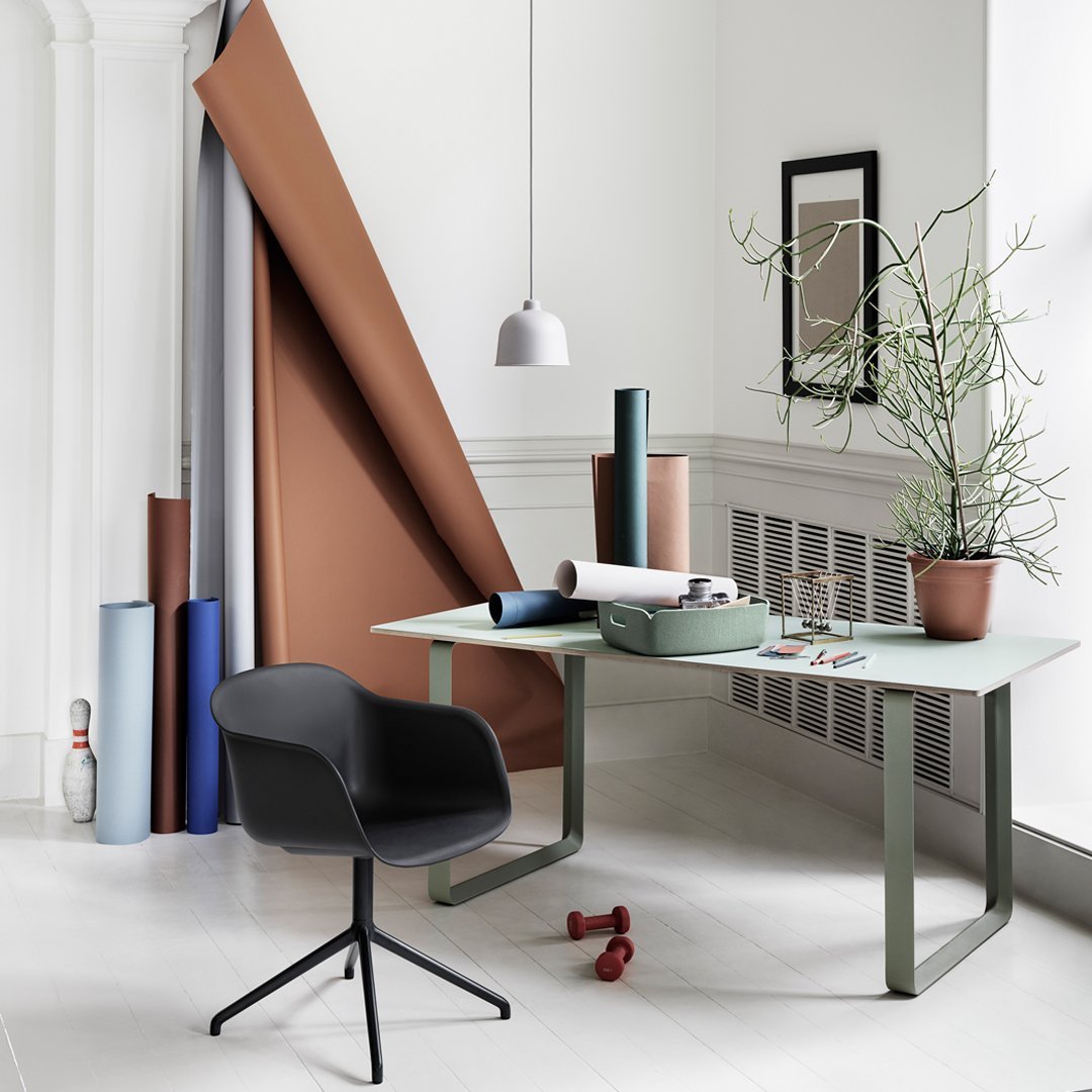 Modern workspace featuring soft mint green, rich brown, muted blue, and sleek black elements with subtle natural accents.