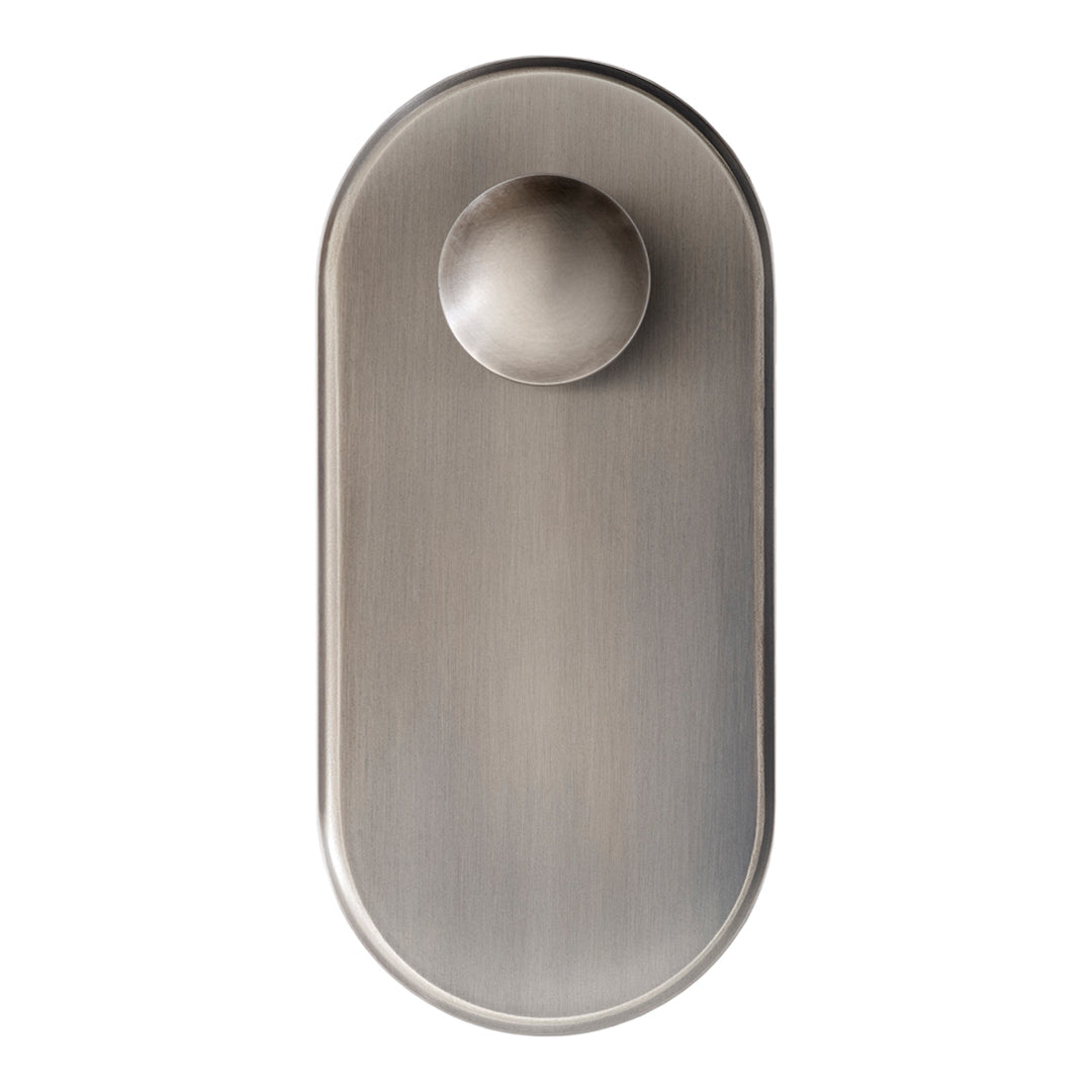 Brushed nickel door knob with an oval backplate and smooth, minimalist design. Elegant metallic finish.