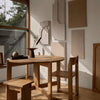 Natural wood tones with subtle textures and soft shadows, featuring minimalist design accents against a light backdrop.