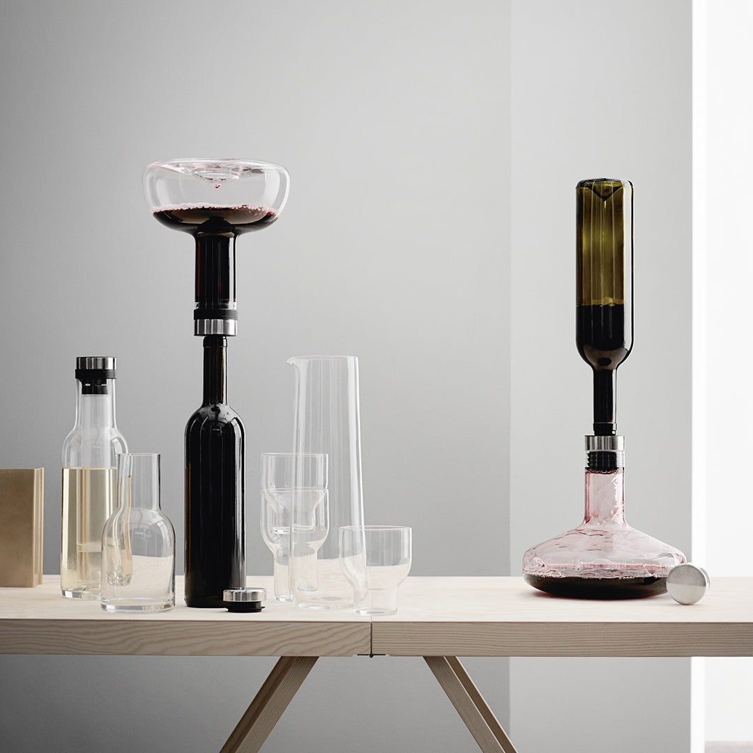 Elegant glassware with black, clear, and green hues; modern shapes and minimalist design for sophisticated dining.