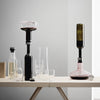 Elegant glassware with black, clear, and green hues; modern shapes and minimalist design for sophisticated dining.