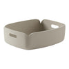 Beige textured storage basket with rounded corners and cut-out handles for easy carrying. Perfect for stylish organization.