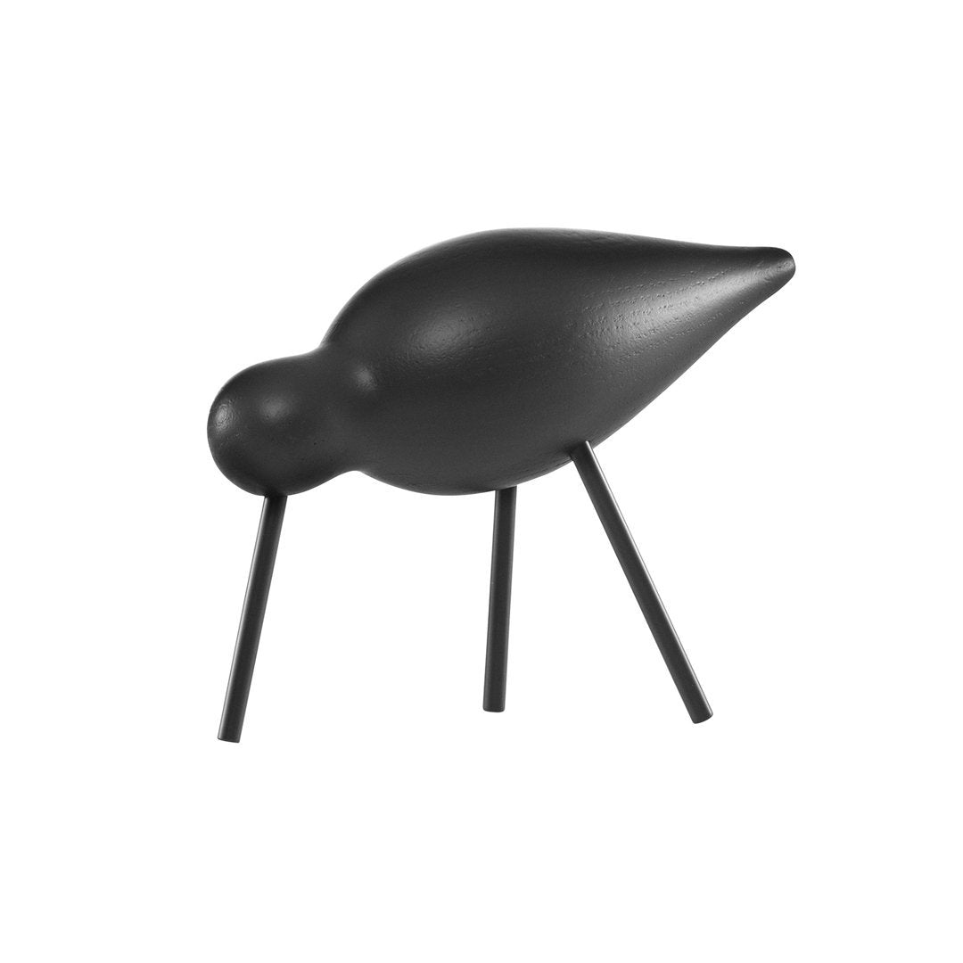 Black bird figurine with a smooth finish and minimalist design, featuring three slender legs and a rounded body.