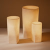 Soft beige decorative lamps in varying heights, featuring a smooth, matte finish and minimalist design.