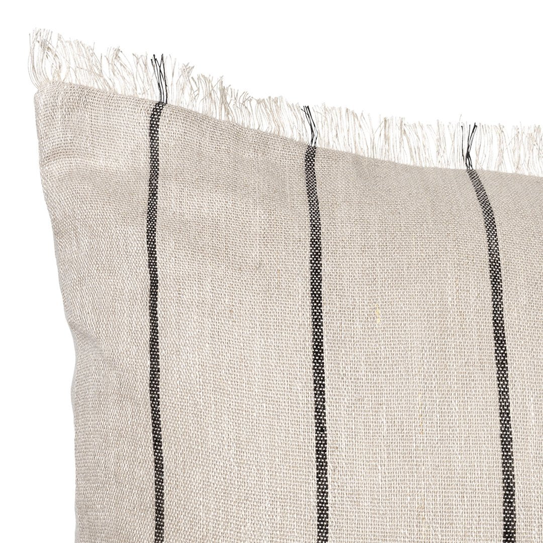 Beige pillow with contrasting black vertical stripes and fringed edges. Perfect for a modern, cozy decor.