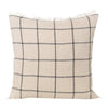Beige plaid cushion with black grid pattern and fringe detailing, perfect for cozy home decor.