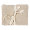 Natural beige linen fabric bundle tied with a cream ribbon. Soft texture with a simple, elegant look.