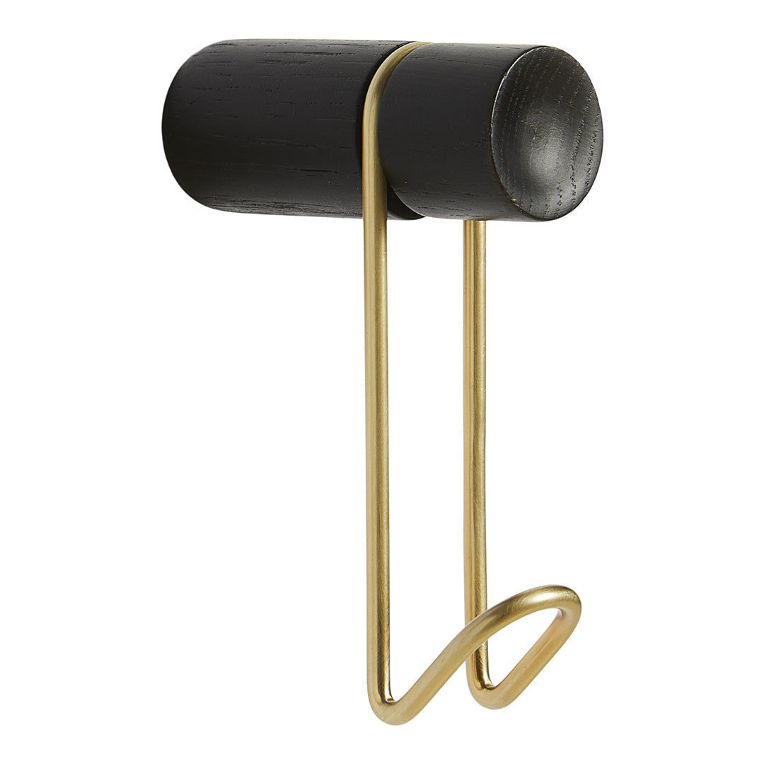 Black cylindrical wall hook with a sleek gold metal loop design. Modern and stylish accessory for any room.