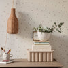 "Neutral tones with subtle polka dot pattern, featuring natural textures and greenery for a stylish decor accent."
