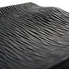 Black textured surface with wavy grooves, creating a dynamic pattern and rich visual depth. Ideal for stylish decor.