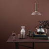 Neutral-toned decor featuring clay, beige, and gray vases against a warm brown backdrop. Modern and minimalist design.