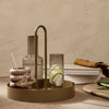 "Elegant olive green tray with minimalist glass and ceramic decor, featuring soft neutral tones and natural textures."