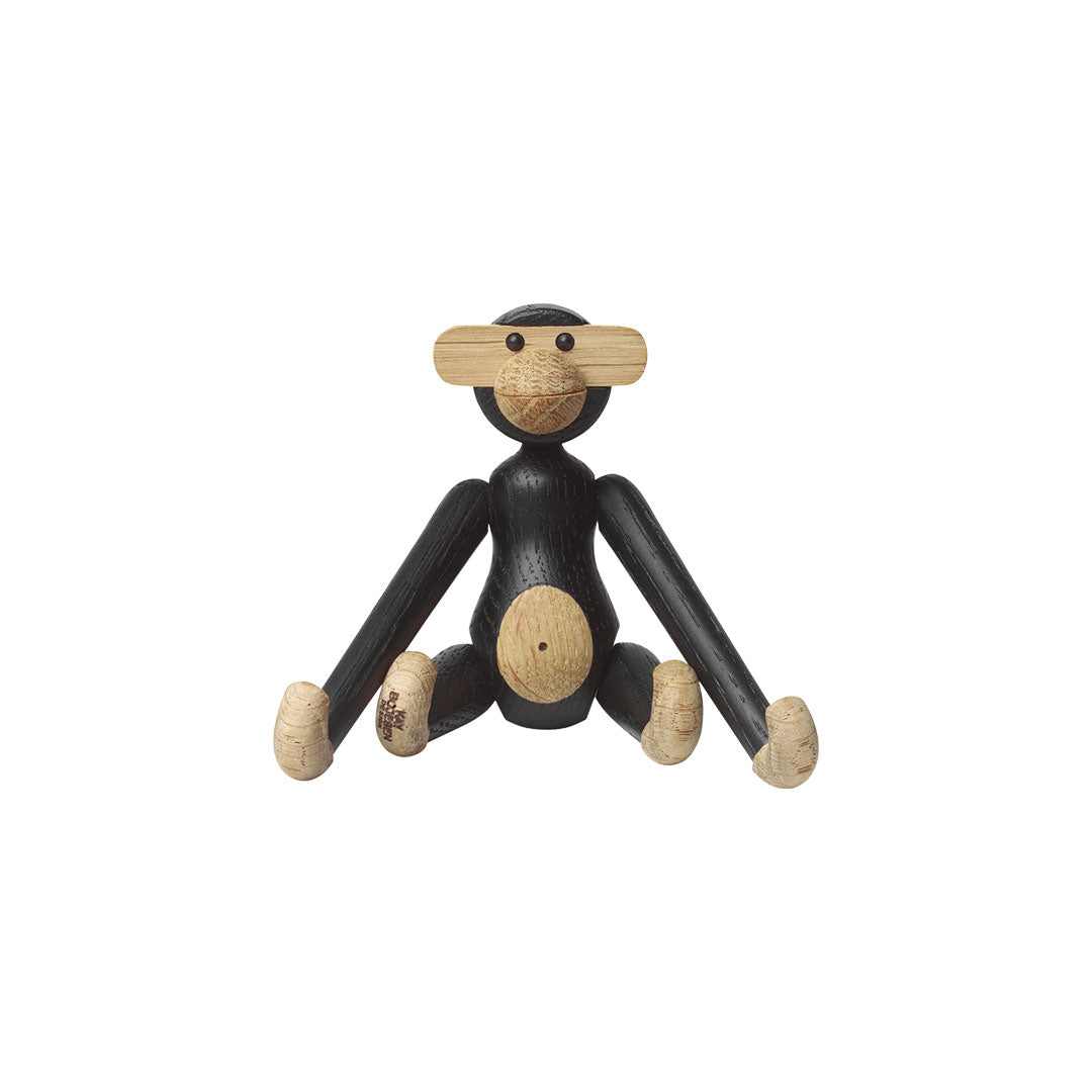 Black and natural wooden monkey figurine with simple design and playful features. Perfect for home decor.