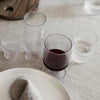 Assorted ribbed glassware in clear and smoky hues, showcasing a modern, elegant design. Ideal for stylish dining.