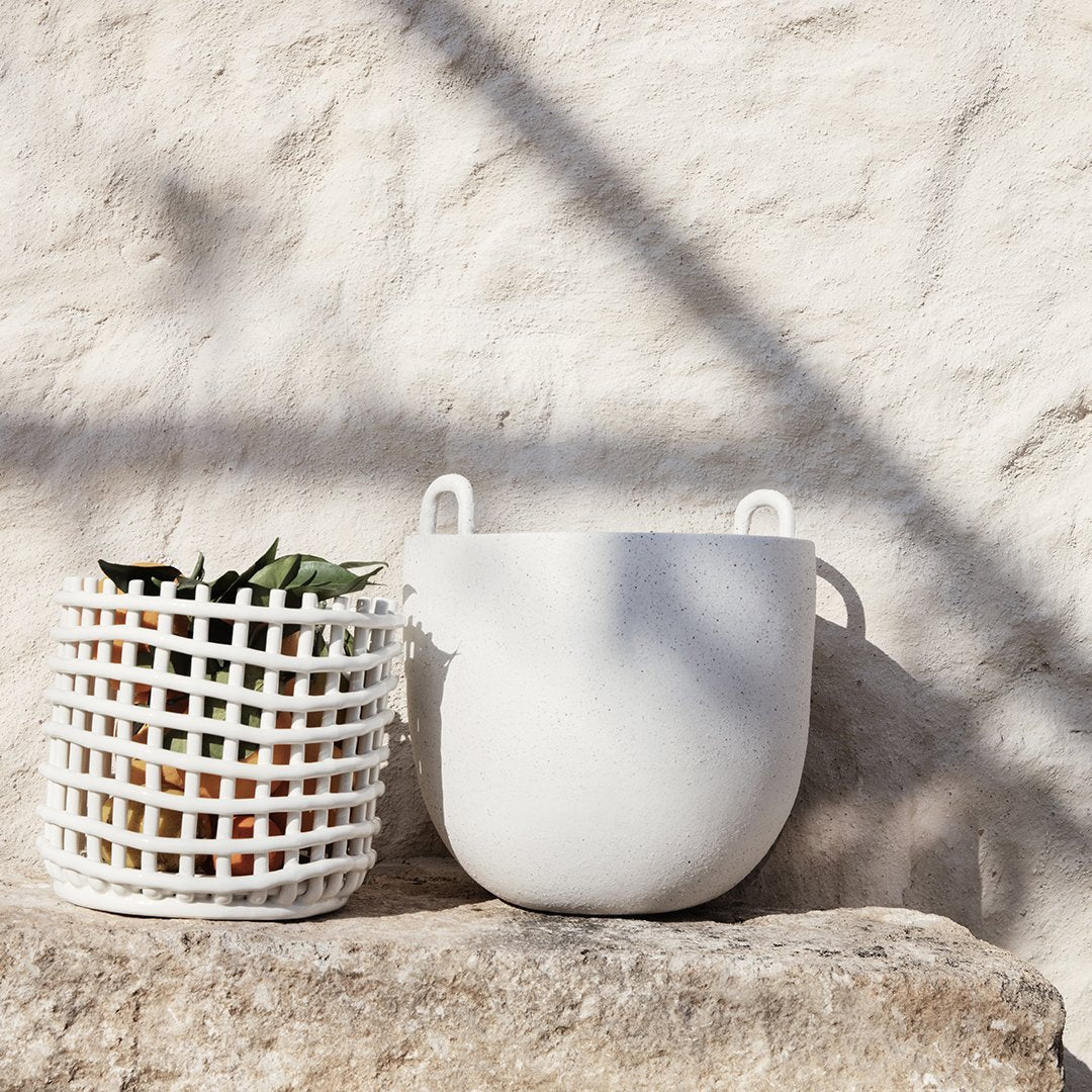 White textured planter and grid-patterned pot, showcasing minimalistic design against a natural backdrop.