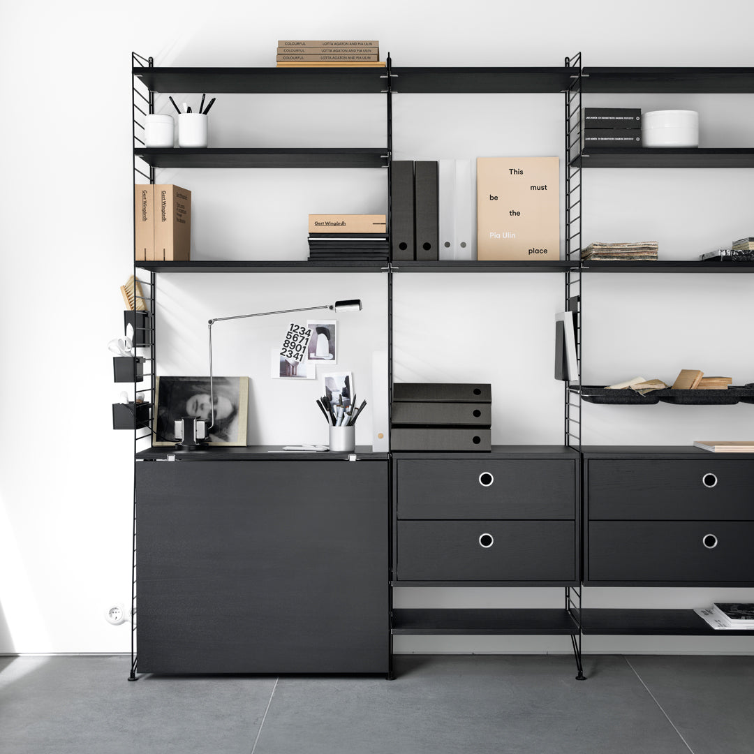 Modern black shelving unit with an industrial design, featuring sleek lines, geometric patterns, and subtle textures.