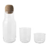 Clear glass carafe and two drinking glasses with a natural cork lid, showcasing minimalist design and smooth textures.