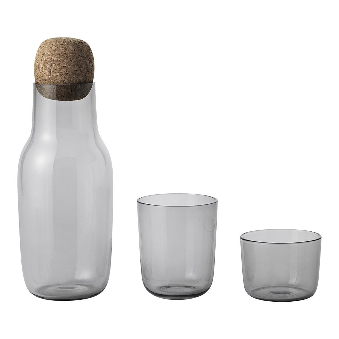 Gray glass carafe with cork stopper and two matching cups. Sleek, modern design with minimalist aesthetics.
