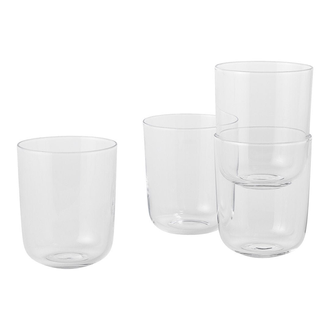 Set of four clear glass tumblers with a smooth, minimalist design, showcasing transparent elegance and modern flair.