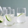 Clear glass tumblers with minimalist design, featuring bubbles and lime slices against a soft pastel background.