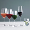 "Five elegant wine glasses showcasing vibrant colors: peach, red, green, deep purple, and clear with mint leaves."