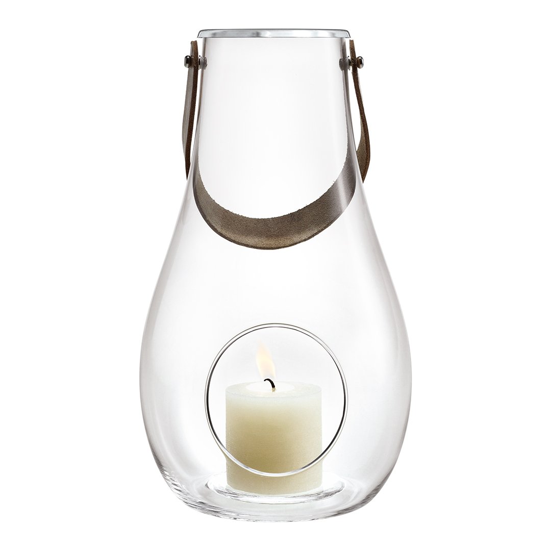 Clear glass lantern with a light gray accent strap, featuring a round cutout showcasing a white candle inside.