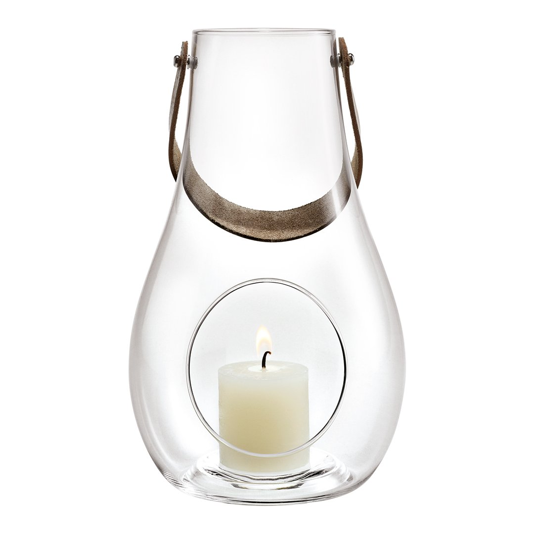 Clear glass lantern with a silver handle and circular base, featuring a creamy white candle inside.