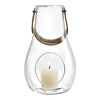Clear glass lantern with a silver handle and a white candle inside, featuring a minimalist design and smooth contours.