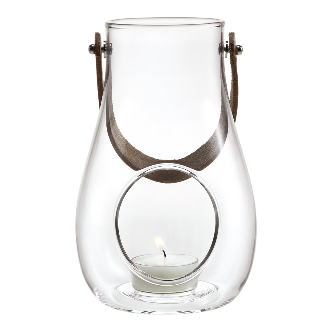 Clear glass lantern with a round cutout and light brown handle. Simple, modern design complements any decor.
