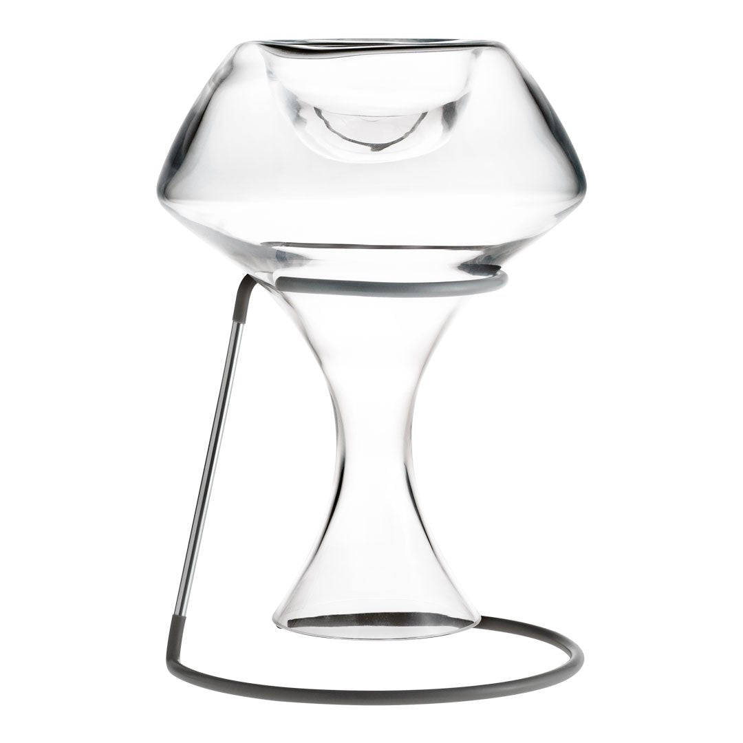 Clear glass vase with a sleek, modern design and minimalist metal stand, featuring smooth curves and a polished finish.