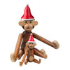 Brown wooden monkey figurines wearing red and white Santa hats, showcasing a playful holiday theme.