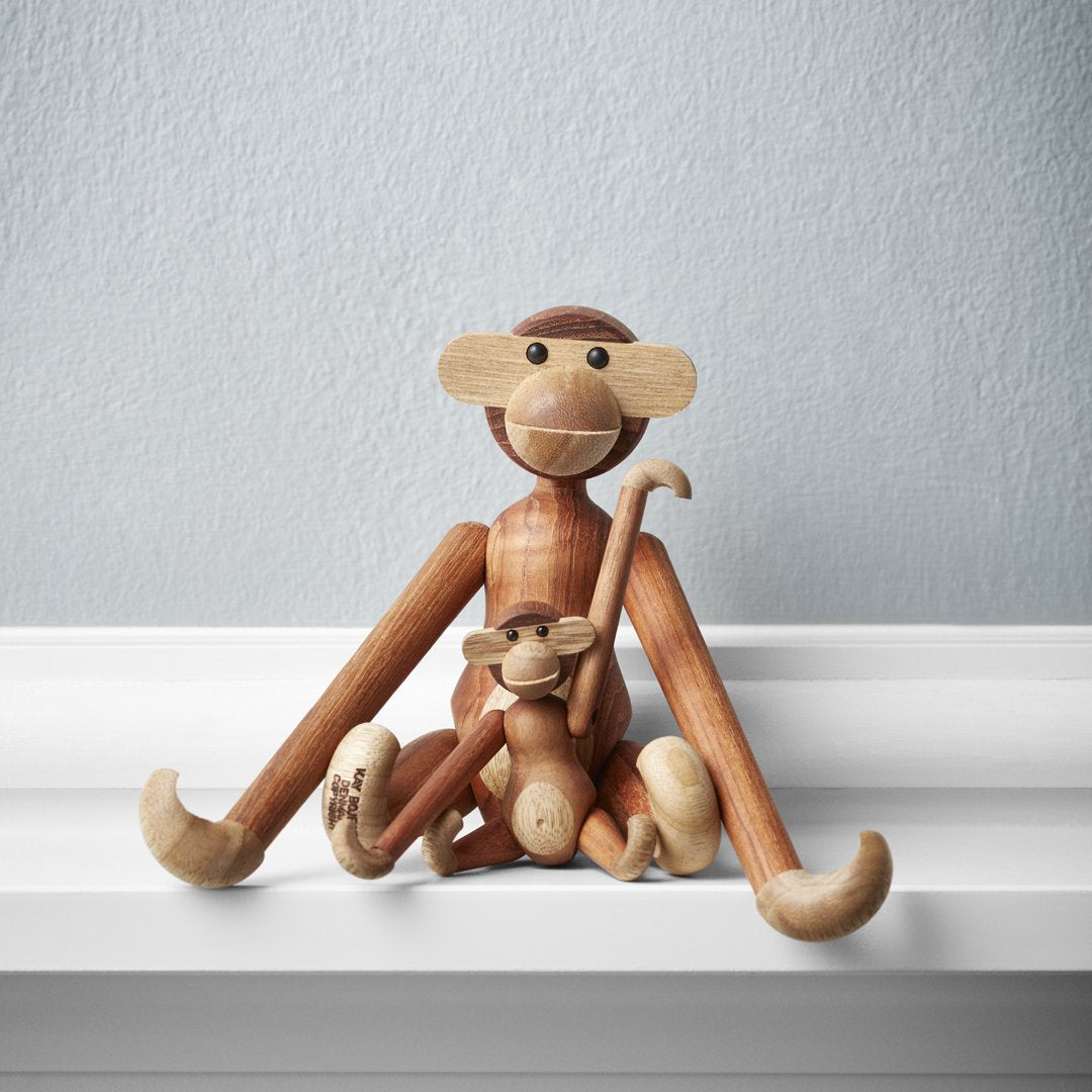 Wooden monkey figurines in natural wood tones, showcasing smooth finishes and playful, whimsical designs.