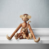 Wooden monkey figurines in natural wood tones, showcasing smooth finishes and playful, whimsical designs.