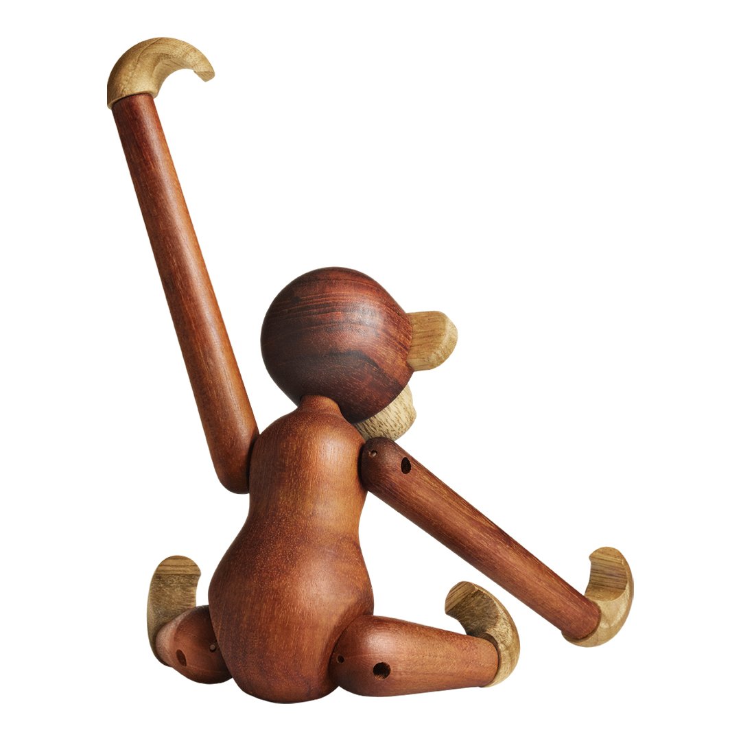 Wooden monkey figurine with warm brown tones and smooth, light wood accents. Playful design with curved limbs.
