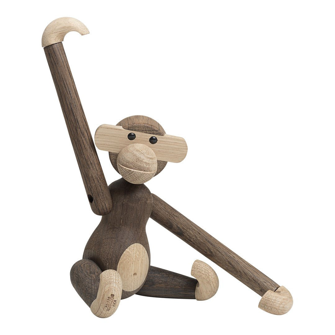 Wooden monkey figurine with a mix of light and dark brown tones; smooth finishes and simple, playful design.