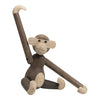 Wooden monkey figurine with a mix of light and dark brown tones; smooth finishes and simple, playful design.