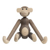 Wooden monkey figure featuring a mix of natural brown and light beige tones with smooth, rounded shapes.