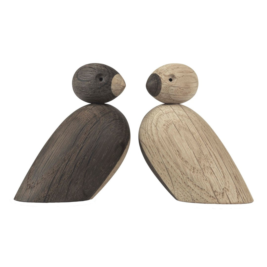 Wooden bird figurines in dark brown and light beige with smooth, curved shapes and natural wood grain patterns.
