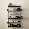Black shelving unit with multiple levels, featuring minimalist geometric shapes and clean lines against a light wood wall.