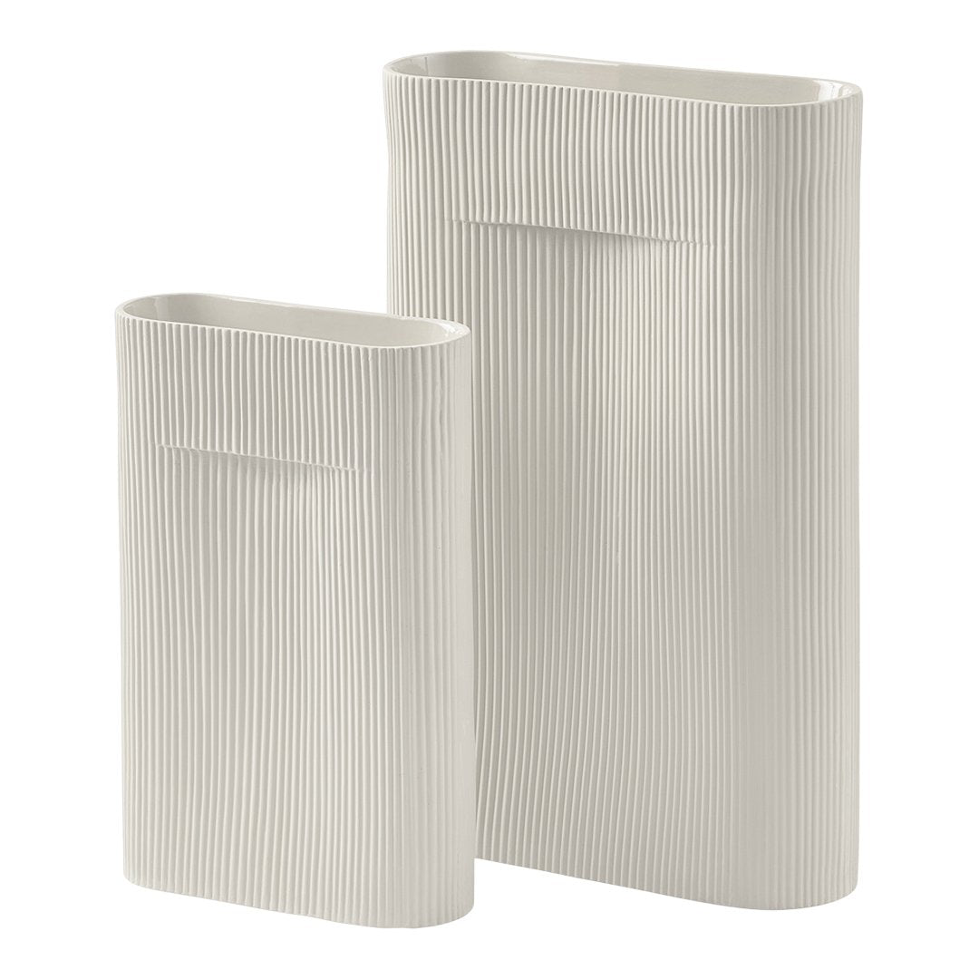 Textured white ceramic vases with vertical ribbed patterns, available in two sizes for stylish decor.