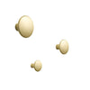 Three smooth, round wall hooks in a soft matte gold finish, varying in sizes for a minimalist decor.