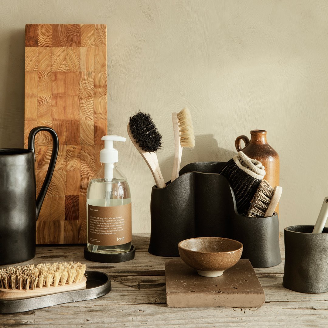 Black ceramic holders, wooden textures, natural tones; minimalist kitchenware with earthy colors and subtle patterns.